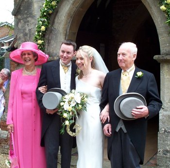 Using a hat to hide his obvious excitement about being married.